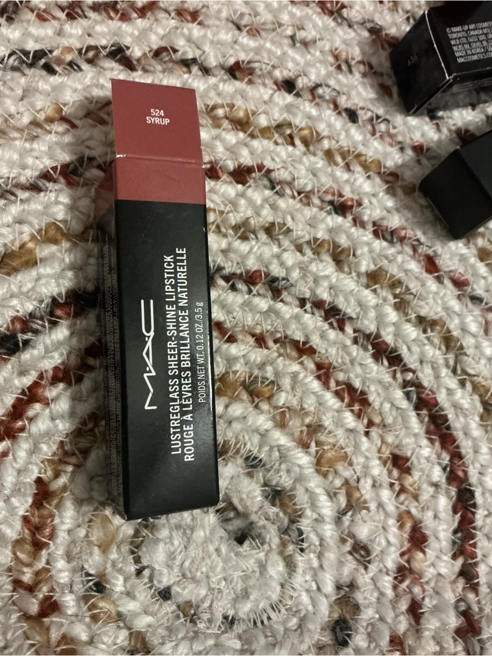 Lipstick box on rug